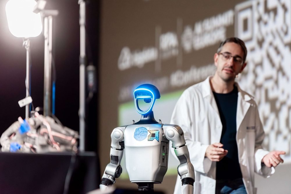 Speaker presenting a humanoid robot on the AI Summit Europe stage